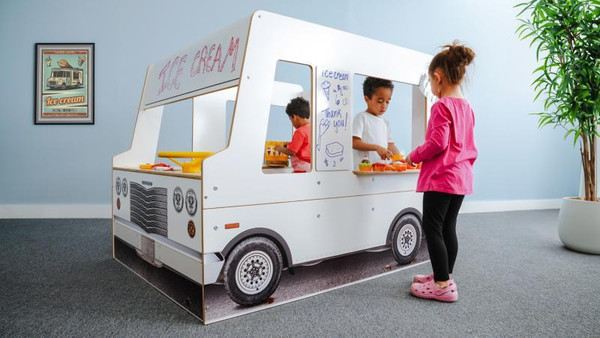 Whitney Brothers Imagination Children's Food Truck, children playing inside and around a kids' pretend play food truck with colorful food items and a whiteboard menu.